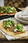 Wholemeal pizza topped with grilled vegetables, ricotta & rocket