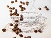 Coffee beans and drawing of a coffee cup and saucer