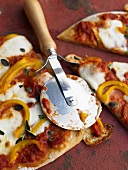 Cutting up pizza Margherita with pizza cutter