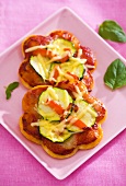 Flower-shaped pizzas with courgettes and cheese for children