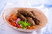 Lamb skewers with tomato salad
