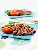 Sliced beefsteak with grilled tomato and green beans