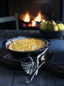 Clafoutis on table in front of open fire