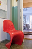 A red chair in a corridor