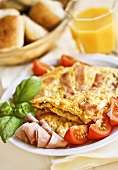 Omelette with ham, tomatoes and basil