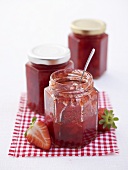 Several jars of strawberry jam