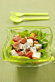 Spinach salad with pancetta, blue cheese, tomatoes and basil