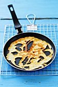 Holey pancake in frying pan