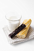 Baguette, chocolate and glass of milk
