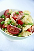 Pasta salad with peas, salami and tomatoes