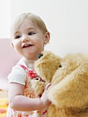Little girl with toy dog