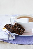 Chocolate brownies beside cup of coffee