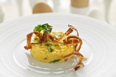 Scrambled egg with crispy bacon and ramsons (wild garlic)