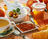 Apple jelly, apple tea, teapot and croissant