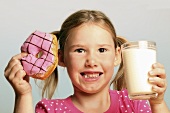 Girl with doughnut and milk