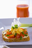 Scrambled egg with tomatoes and herbs on wholemeal bread