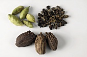 Brown and green cardamom pods and cardamom seeds