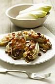 Baked chicory with pancetta and hazelnuts