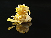 Fettuccine against a black background