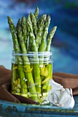 Green asparagus in olive oil and garlic marinade