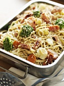 Spaghetti with vegetables, ham & Parmesan in a roasting tin