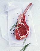 Frenched lamb chop with pepper and rosemary on waxed paper