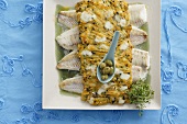 Fish fillets with potato and olive topping