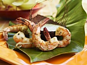Grilled coconut prawns with coconut dip on banana leaf