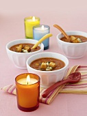 Gazpacho in three bowls, candles