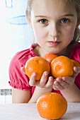 Girl with mandarin oranges