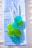 Blue and green lollipops on checked cloth