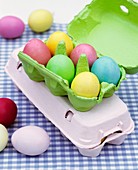 Coloured Easter eggs in egg box