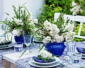 Blue and white table decorations with lilac and grasses