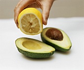 Sprinkling avocado flesh with lemon juice