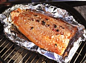 Smoked salmon with chilli in aluminium foil on barbecue