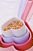 Coloured sprinkles in heart-shaped dish