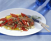 Wels catfish with tomatoes, capers and garlic