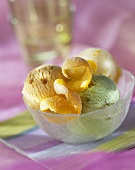 Small bowl of pistachio ice cream with orange peel