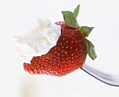 Strawberry and cream on fork
