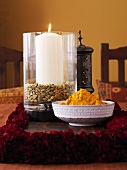 Bowl of Indian spice mixture and a candle