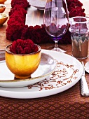 Festive place-setting with red carnation
