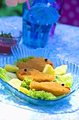 Breaded fish-shaped fish fillets with pineapple