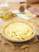 Making apple pie: lined pie dish filled with apple slices