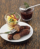 Grilled sausage with potato salad and red wine sauce