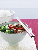Chicken and vegetable stir-fry with chopsticks