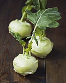 Three kohlrabies on wooden background