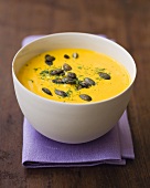 Cream of pumpkin soup with pumpkin seeds and dill