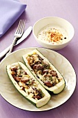 Courgette stuffed with sausage and sprinkled with Parmesan
