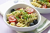 Pasta salad: fusilli, olives, tomatoes and basil