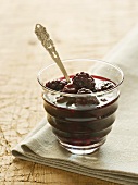 Blackberry jam in a glass with a spoon